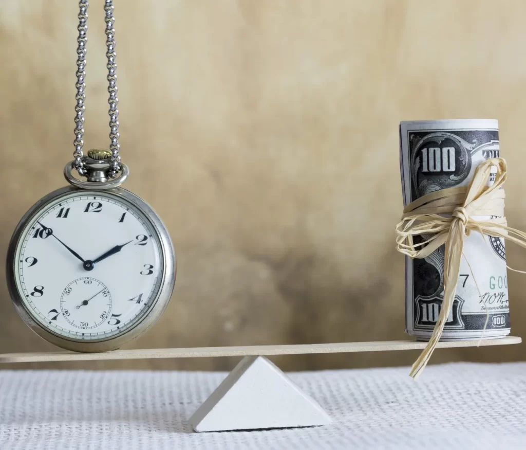 Pocket watch and money on a scale, representing wage & hour issues that our employment law firm handles.